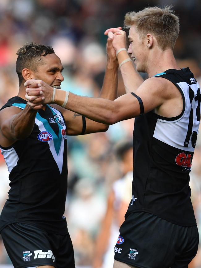 Todd Marshall and Dom Barry of the Power celebrate a goal on Saturday. Picture: AAP Image/David Mariuz