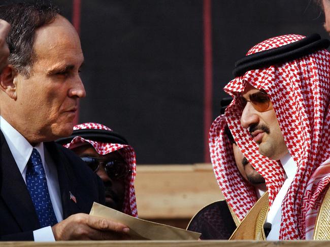 Prince Alwaleed Bin Talal Bin AbdulAziz of Saudi Arabia, Chairman of Kingdom Holding Company (R), hands former New York Mayor Rudolph Giuliani (L) a check for USD 10 million for the Twin Towers Fund in New York. Picture: AFP