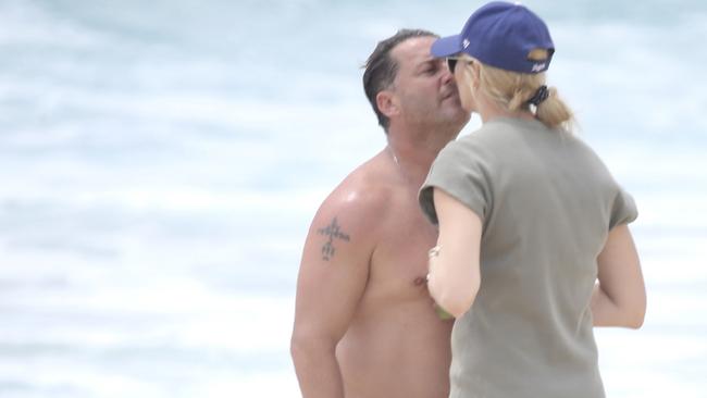 Karl Stefanovic kisses wife, Jasmine, on the beach in Noosa earlier this year. Picture: BACKGRID Australia.