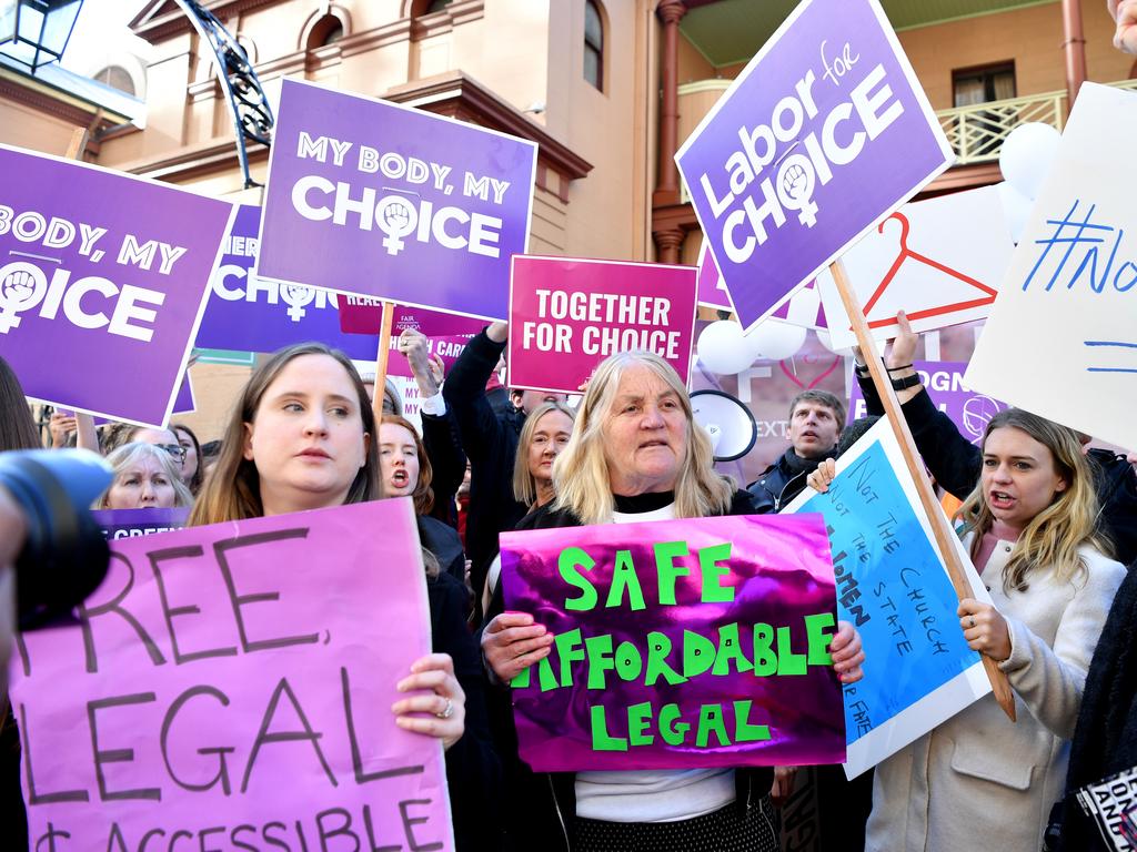 Pro-choice advocates hold placards during a rally outside the New South Wales Parliament house in Sydney, Tuesday, August 6, 2019. (AAP Image/Joel Carrett)