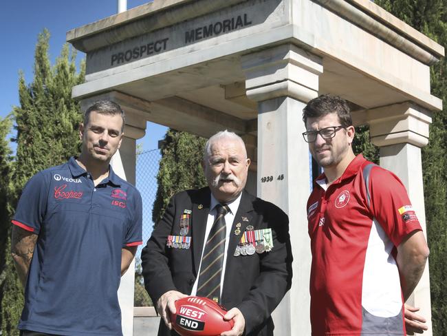 North Adelaide coach Josh Carr and Norwood coach Jarrod Cotton at Prospect Memorial, with Prospect RSL President, John Hadaway, ahead of the Anzac Day clash. Picture: Dean Martin