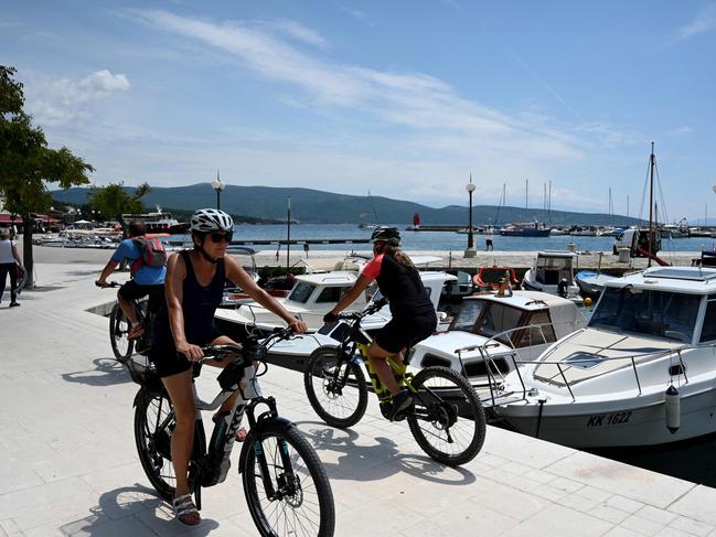 Tourists ride bikes on the Croatian island of Krk. Europe wants to see an increase in tourism this summer. Picture: AFP