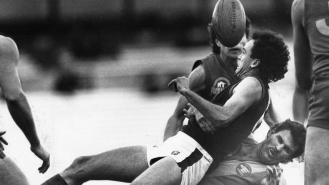 Norwood’s Michael Aish is tackled during a clash with West Torrens in 1990. Picture: Neon Martin 