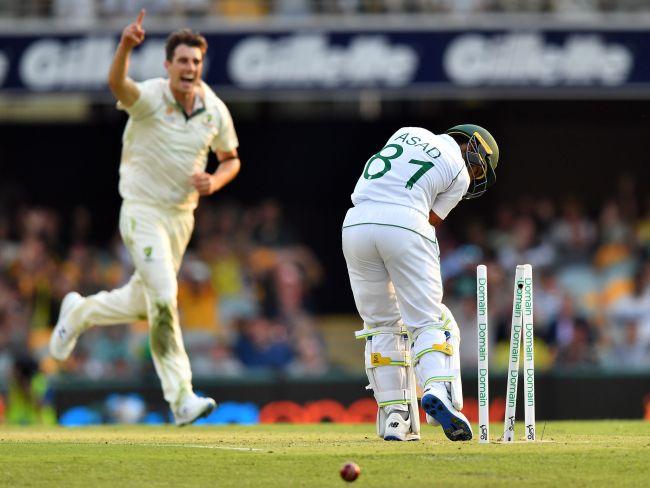 Pakistan's Asad Shafiq (R) has his stumps rearranged by Pat Cummins. Picture: AFP