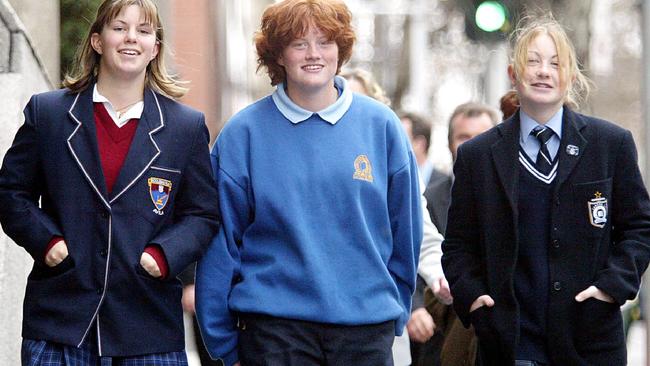 Penny Cula-Reid (right) with Helen Taylor (left) and Emily Stanyer outside VCAT in 2003 during their case against AFL Victoria.