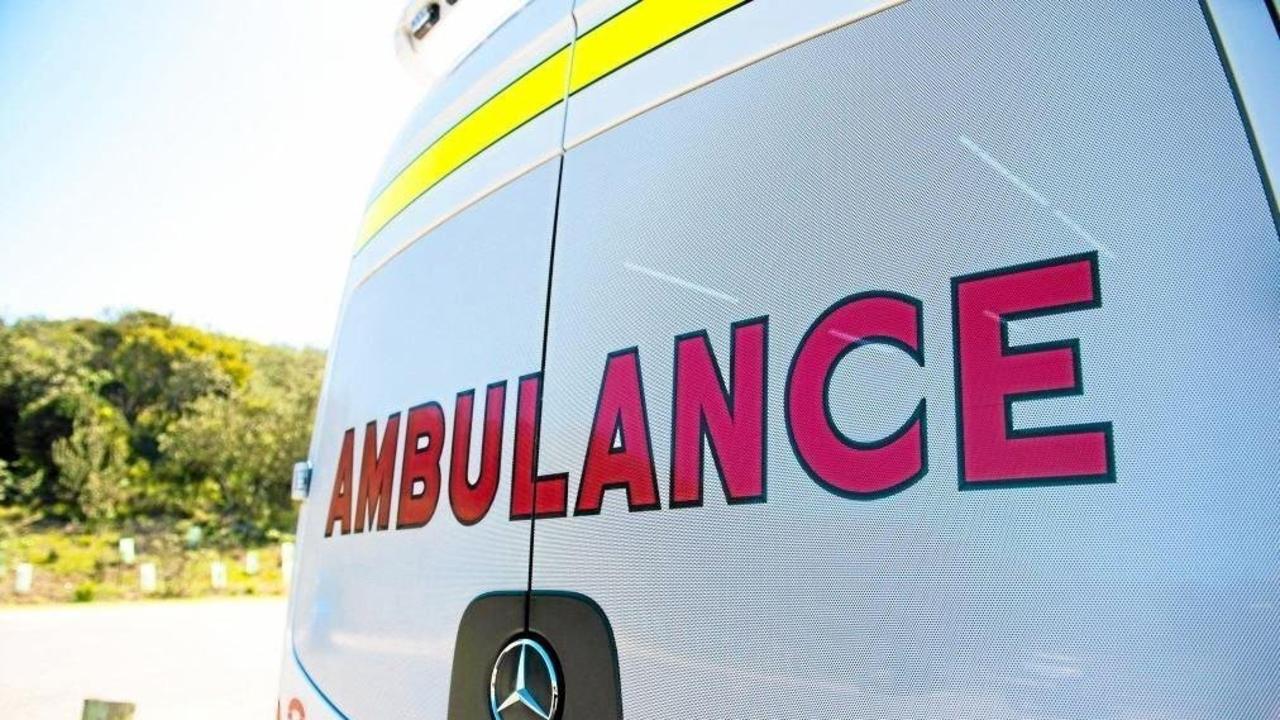 A man in his 20s has been taken to hospital after his car crashed into a truck on the Warrego Highway.