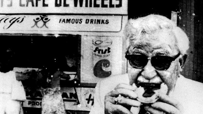 Kentucky Fried Chicken founder Colonel Sanders enjoys a pie from Harry's Cafe De-Wheels at Woolloomoolo, 1974.