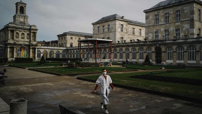 A medical staff member walks in the main court of the Lariboisiere Hospital in Paris. Picture: AFP