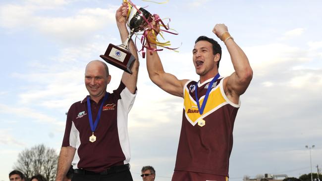 Lower Plenty coach Gary Ramsay and captain Billy Barden lift the premiership cup. Picture: Robert Mckechnie