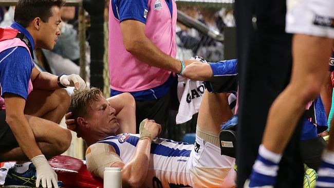 Jack Ziebell has his right knee checked by medical staff.