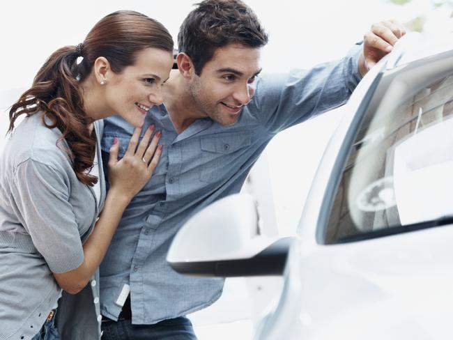 Generic photo of a couple buying a car