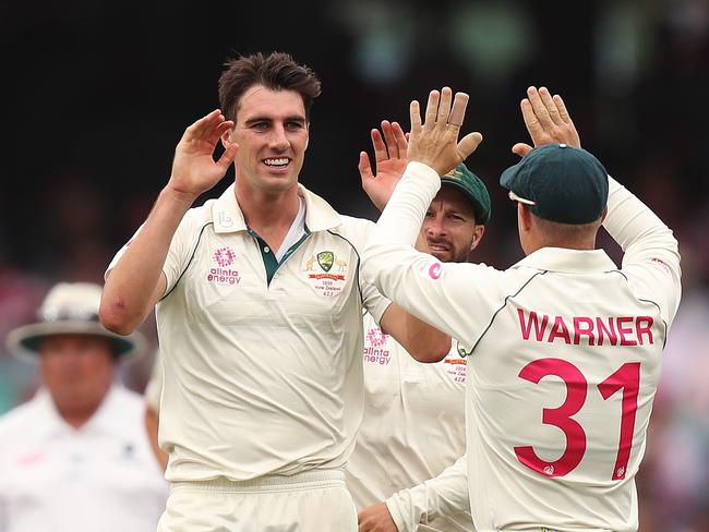 Australia's Pat Cummins celebrates the wicket of Glenn Phillips.