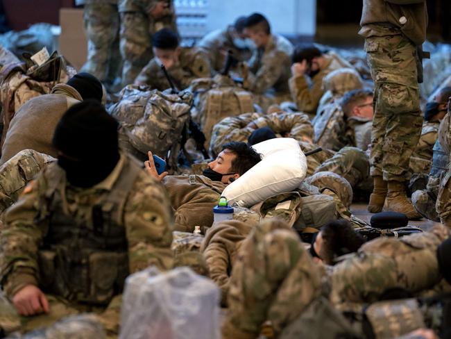 Members of the National Guard sleep in the Visitor Centre of the US Capitol as security beefs-up for the inauguration. Picture: Getty Images/AFP