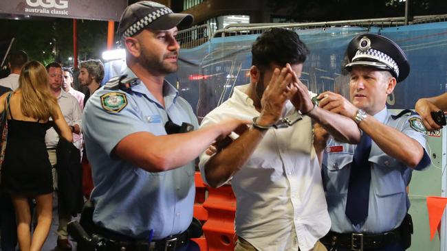 A man is taken away by police at The Establishment. Picture: Bill Hearne