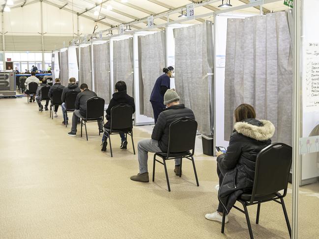 People wait in line at a Covid-19 vaccination hub at the Melbourne Showgrounds. Picture: Getty Images