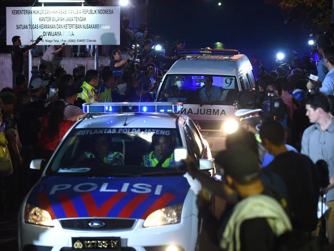 The pain will never end ... A police car escorts an ambulance carrying a coffin bearing the body of one of the eight drug convicts executed at Nusakambangan on April 29, 2015. Picture: AFP / Romeo Gacad