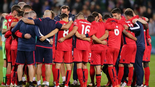 Reds players huddle after the team’s defeat during the A-League semi final match to Perth Glory in Perth. Photo: Will Russell/Getty Images