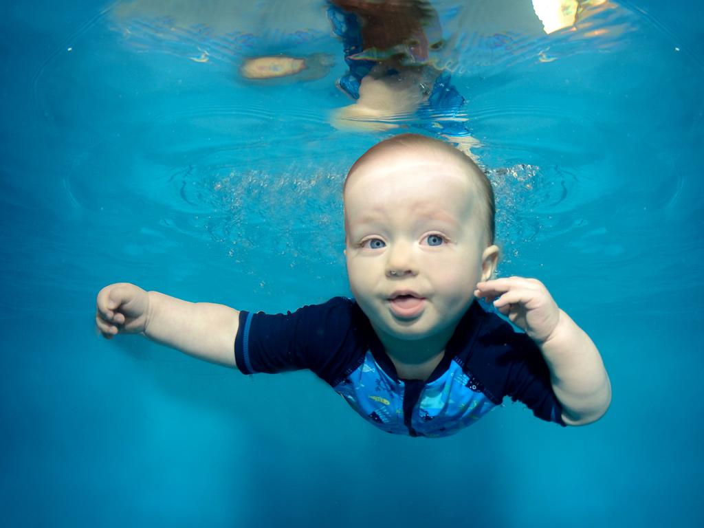 Kids smile for the underwater camera | Daily Telegraph