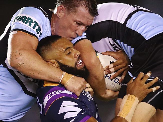 SYDNEY, AUSTRALIA - MARCH 30: Joshua Addo-Carr of the Storm is tackled by the Sharks defence during the round four NRL match between the Cronulla Sharks and the Melbourne Storm at Southern Cross Group Stadium on March 30, 2018 in Sydney, Australia.  (Photo by Brendon Thorne/Getty Images)