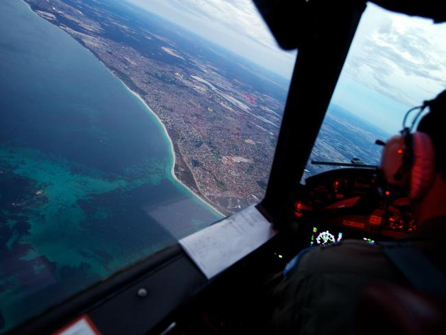 Crew on-board an RAAF AP-3C Orion crosses the coast of Perth, having just completed an 11 hour search mission for MH370. Picture: Getty.