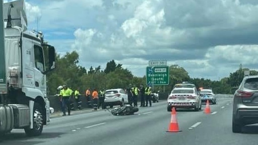 Emergency crews at the scene of a motorcycle and vehicle crash along the M1 at Beenleigh. Picture: Jason Stevens