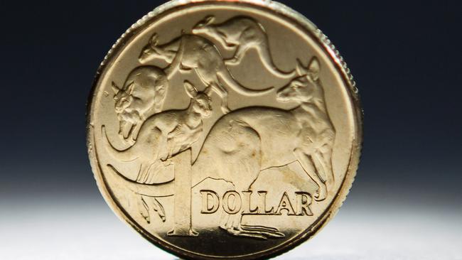 An Australian one-dollar coin is arranged for a photograph in Sydney, Australia, on Wednesday, April 17, 2013. Direct trading between the Australian dollar and yuan started on April 10. Photographer: Ian Waldie/Bloomberg