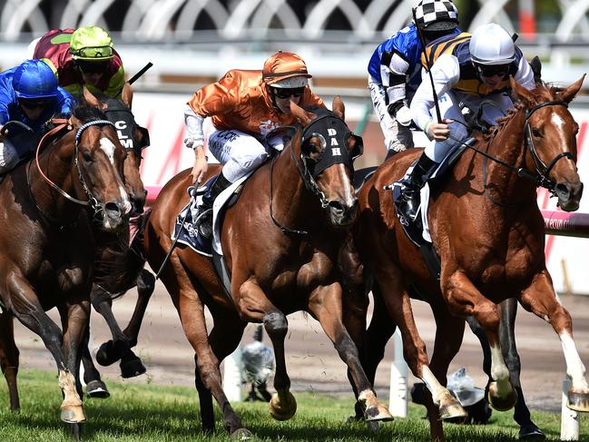 Gail Chop (right) ridden by Ben Pelham gallops to victory in the Mackinnon Stakes ahead of Rising Romance (centre) who finished second and Contributor (left) who finished third at Flemington racecourse in Melbourne, Saturday, Oct. 31, 2015. (AAP Image/Julian Smith) NO ARCHIVING, EDITORIAL USE ONLY