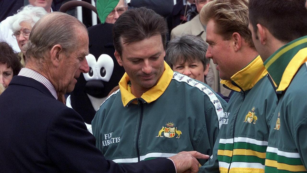 Prince Philip, Duke of Edinburgh, left, discusses the Australian World Cup playing strip with cricketers Steve Waugh, centre, and Shane Warne at Worcester Cricket Club, May 10, 1999. Picture: Supplied