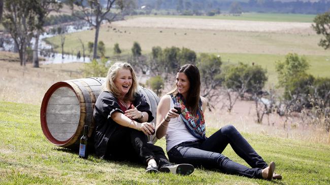 Victoria Carthew and Amy Peel enjoy a wine in the sun at Moffatdale Ridge Winery, owned by Jason Kinsella, in the South Burnett. Picture: Megan Slade