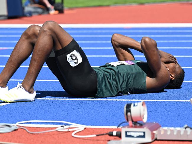 Zambia's Muzala Samukonga collapses after competing during the men's 400m Round 1 athletics event at the Alexander Stadium, in Birmingham on day six of the Commonwealth Games in Birmingham, central England, on August 3, 2022. (Photo by Andy Buchanan / AFP)