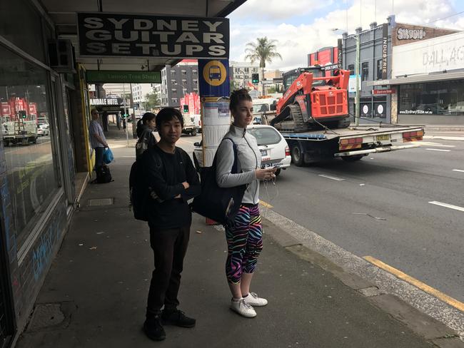 Sydney University student Daniel Thant Nay Hsu and Genevieve Rogan waiting for the bus at Annandale on the day the bus drivers were on strike in the inner west.