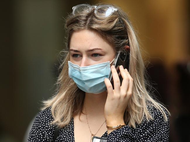 SYDNEY, AUSTRALIA - DECEMBER 24: A shopper walks in Sydney's CBD on December 24, 2021 in Sydney, Australia. New COVID-19 rules have come into effect as of midnight, with masks required in indoor settings. The new rules have been introduced in an effort to slow the spread of the Omicron variant, following a surge of new COVID-19 cases across the state. From Monday 27 December, QR code check ins will once again be compulsory, including for hospitality and retail, while hospitality venues, including pubs, clubs, restaurants and cafes will move to 1 person per 2 sqm rule indoors, with no density limit for outdoor settings. (Photo by Jason McCawley/Getty Images)