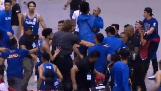 Luc Longley drives straight into the melee, arms outstretched as pushes the players away from Goulding, who is on the ground trying to protect his head.