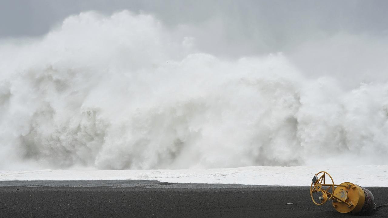 A stricken buoy lies on a beach in front of surging waves as Typhoon Hagibis approaches in Kumano, Mie prefecture, central Japan. Picture: AP