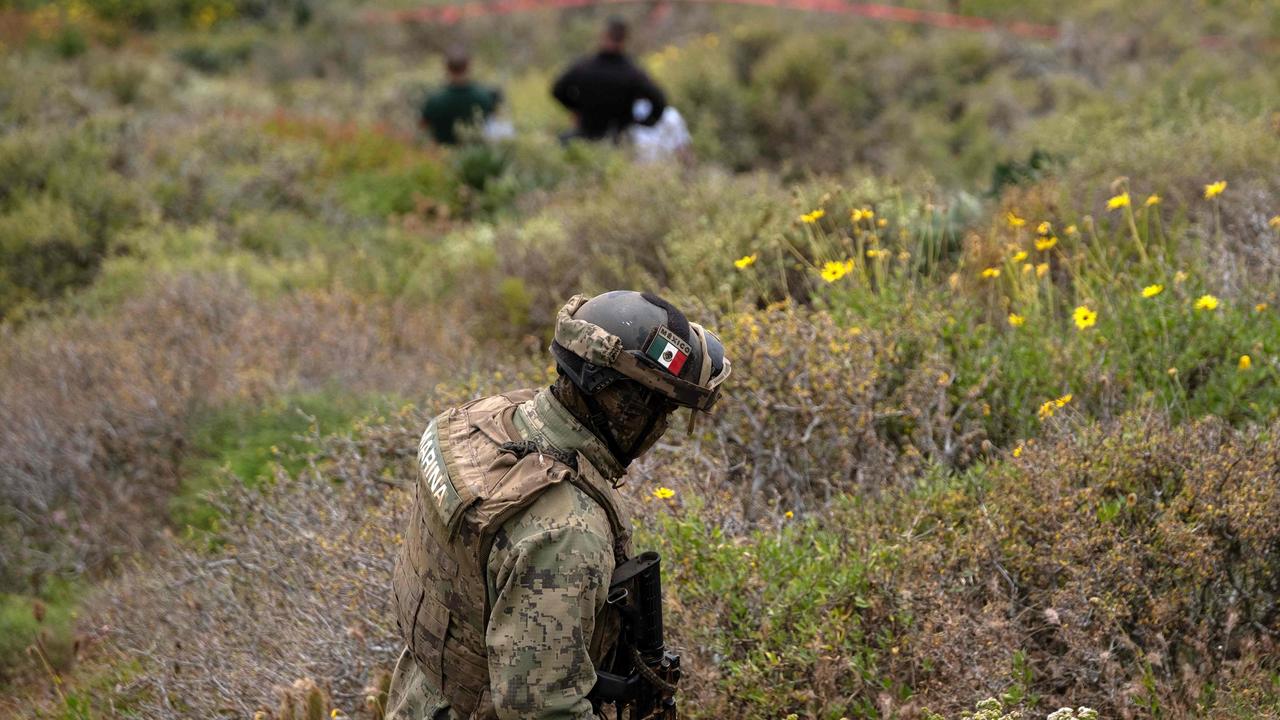 A Mexican navy officer near the scene where human remains were found near La Bocana Beach. Picture: Guillermo Arias/AFP