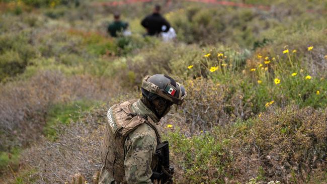 A Mexican navy officer near the scene where human remains were found near La Bocana Beach. Picture: Guillermo Arias/AFP