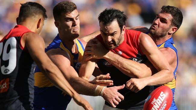 Jordan Lewis of the Demons gets tackled by Scott Lycett and Jack Darling of the Eagles. Picture: Paul Kane/Getty Images