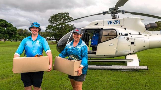 Floody legends Keldon Fletcher, 16, and mother Rae Moody unloading hot meals for distribution in Lucinda during the Hinchinbrook flood disaster. Picture: Supplied