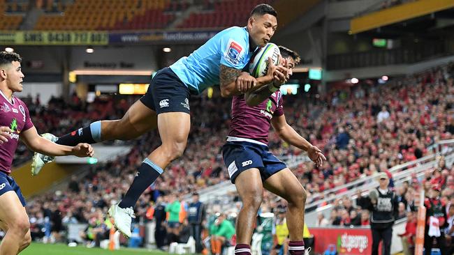 Israel Folau flies high to score against the Reds. Picture: AAP