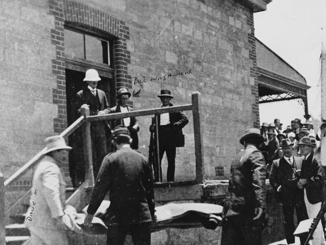 A body (believed to be William John Shaw) being removed from the train station by local undertaker Dave Mangelsdorf (left, in white) and placed into the morgue horse cart. His 18-year-old assistant, Bill Waghorn, is pictured middle of the back row. This photo is owned by Joyce Douglas (Mr WaghornÕs daughter).