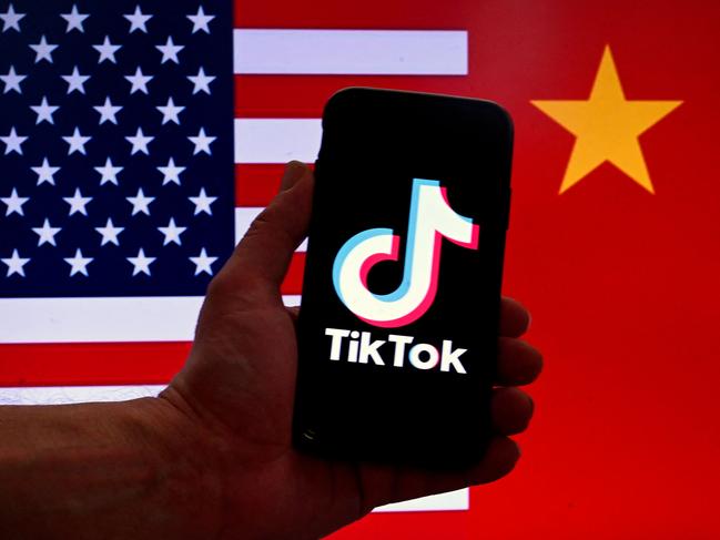 (FILES) In this photo illustration the social media application logo for TikTok is displayed on the screen of an iPhone in front of a US flag and Chinese flag background in Washington, DC, on March 16, 2023. TikTok faces a US ban after an appeals court on December 6, 2024, rejected its challenge to a law requiring the video-sharing app to divest from its Chinese parent company by January 19. The potential ban could strain US-China relations just as president-elect Donald Trump prepares to take office on January 20. (Photo by OLIVIER DOULIERY / AFP)