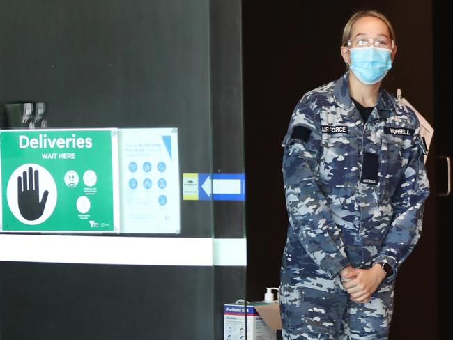 A member of the ADF guards the door of The Pullman Hotel in Melbourne CBD where people who were in COVID quarantine at the Holiday Inn have been transferred. Picture: NCA NewsWire/ David Crosling