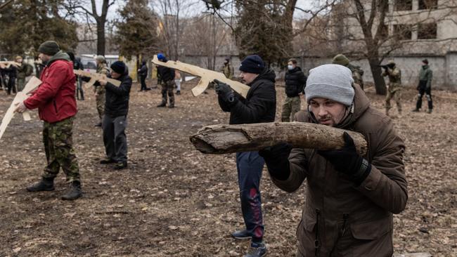 A civilian uses a log as a gun during a military training course, in Kyiv, Ukraine. Across Ukraine thousands of civilians are participating in courses to receive basic combat and survival training as the fear of a Russian invasion continues to escalate. Picture: Getty