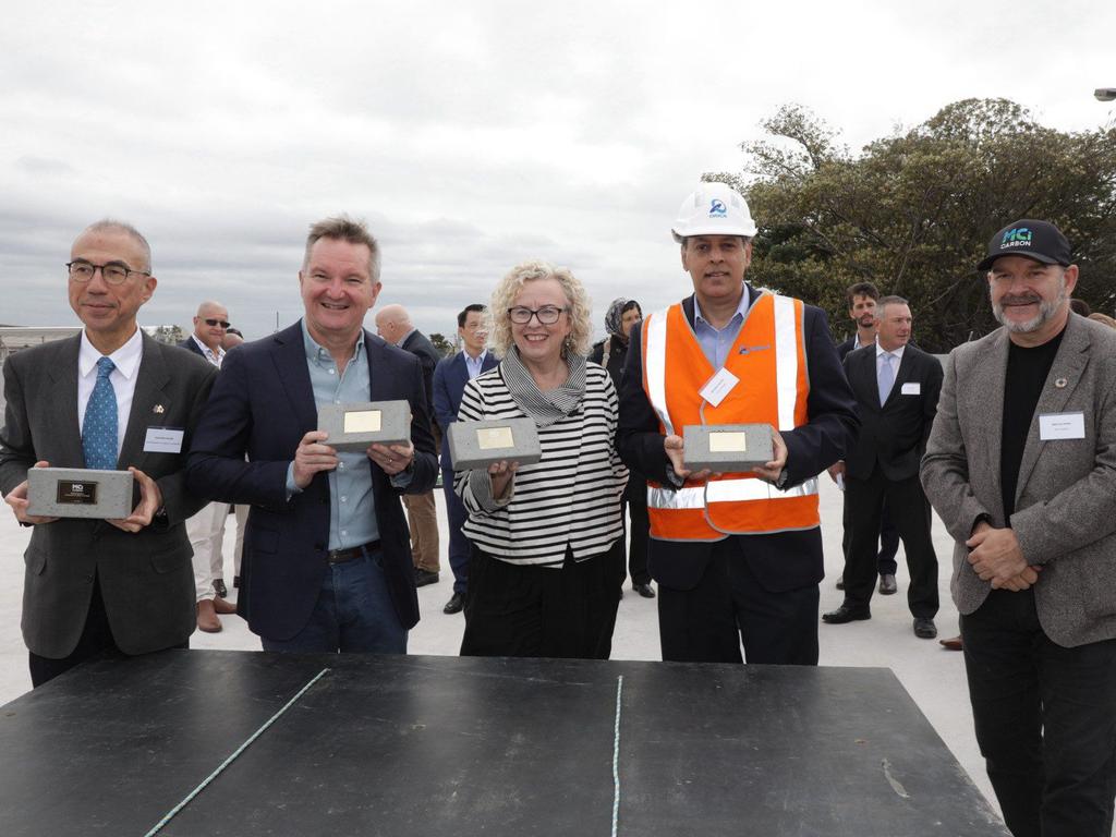 Japanese Ambassador to Australia Suzuki Kazuhiro, Climate Change and Energy Minister Chris Bowen, Federal MP Sharon Claydon, Orica CEO Sanjeev Ghandi and MCi co-founder Marcus Dawe. All but Mr Dawe are posing with MCi low-carbon bricks.