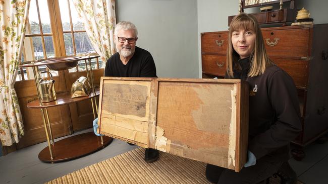 Conservation Officer Michael Smith and Visitor Services Officer Jennifer Dixon with a draw repaired with a Keens and Robinson crate of a chest of draws campaign furniture built in 1840 and owned by convict John Charles Tapp. Picture Chris Kidd