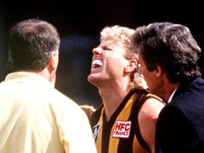 1989 : Dermott Brereton (2nd R) checked by medic after being struck by Mark Yeates during 1989 AFL grand final Geelong v Hawthorn. Pic Ex Melbourne.Australian Rules