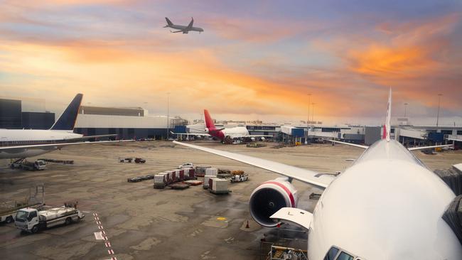 ESCAPE: Cover Story, Dec 17 - "Sydney, Australia - View of airplane at the airport at sunrise. Airplane parked at Sydney International Airport. Picture: Istock