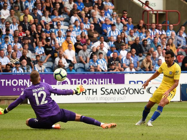 Chelsea's Spanish midfielder Pedro (R) scores the team's third goal past Huddersfield Town's English goalkeeper Ben Hamer during the English Premier League football match between Huddersfield Town and Chelsea at the John Smith's stadium in Huddersfield, northern England on August 11, 2018. (Photo by Oli SCARFF / AFP) / RESTRICTED TO EDITORIAL USE.No use with unauthorized audio, video, data, fixture lists, club/league logos or 'live' services. Online in-match use limited to 120 images. An additional 40 images may be used in extra time. No video emulation. Social media in-match use limited to 120 images. An additional 40 images may be used in extra time. No use in betting publications, games or single club/league/player publications/ /