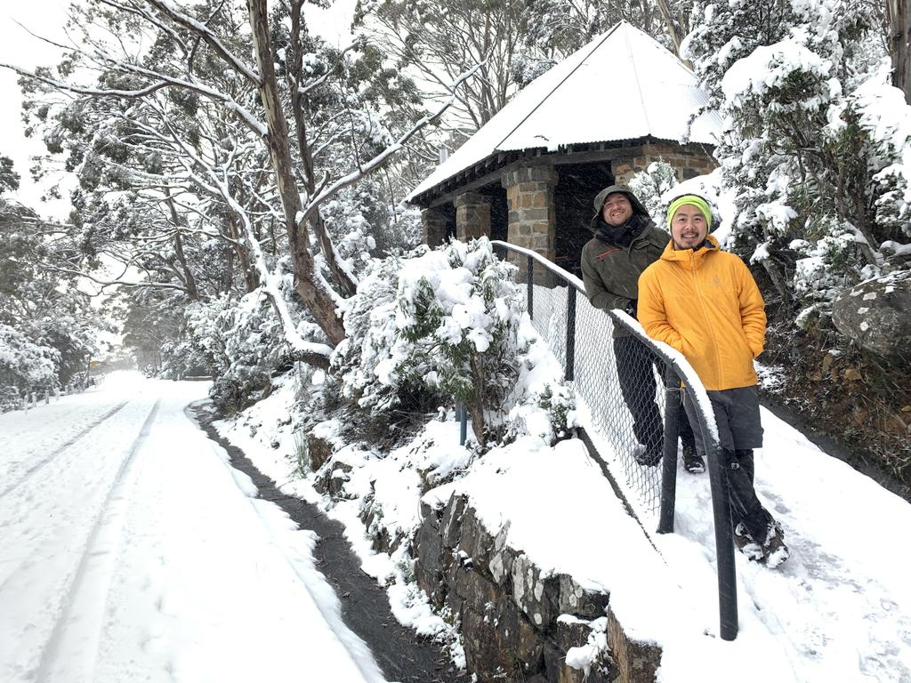 Alex Hormann and Jason Lee enjoy the 20cm deep snow at the Chalet on kunanyi/Mt Wellington on June 7 2022