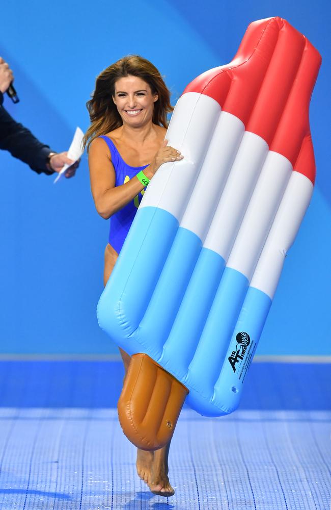 Ada Nicodemou enters the pool deck during a celebrity swimming race on day three of swimming competition at the Gold Coast Commonwealth Games. Picture: AAP Image/Darren England